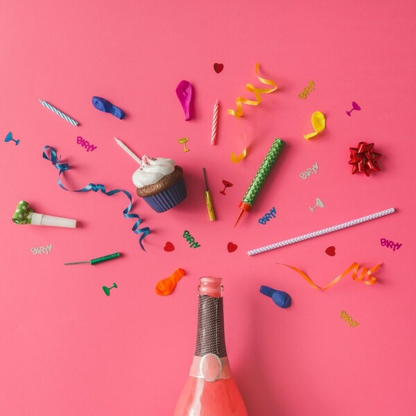 np Champagne bottle with colorful party items on pink background 4MlAy5 free